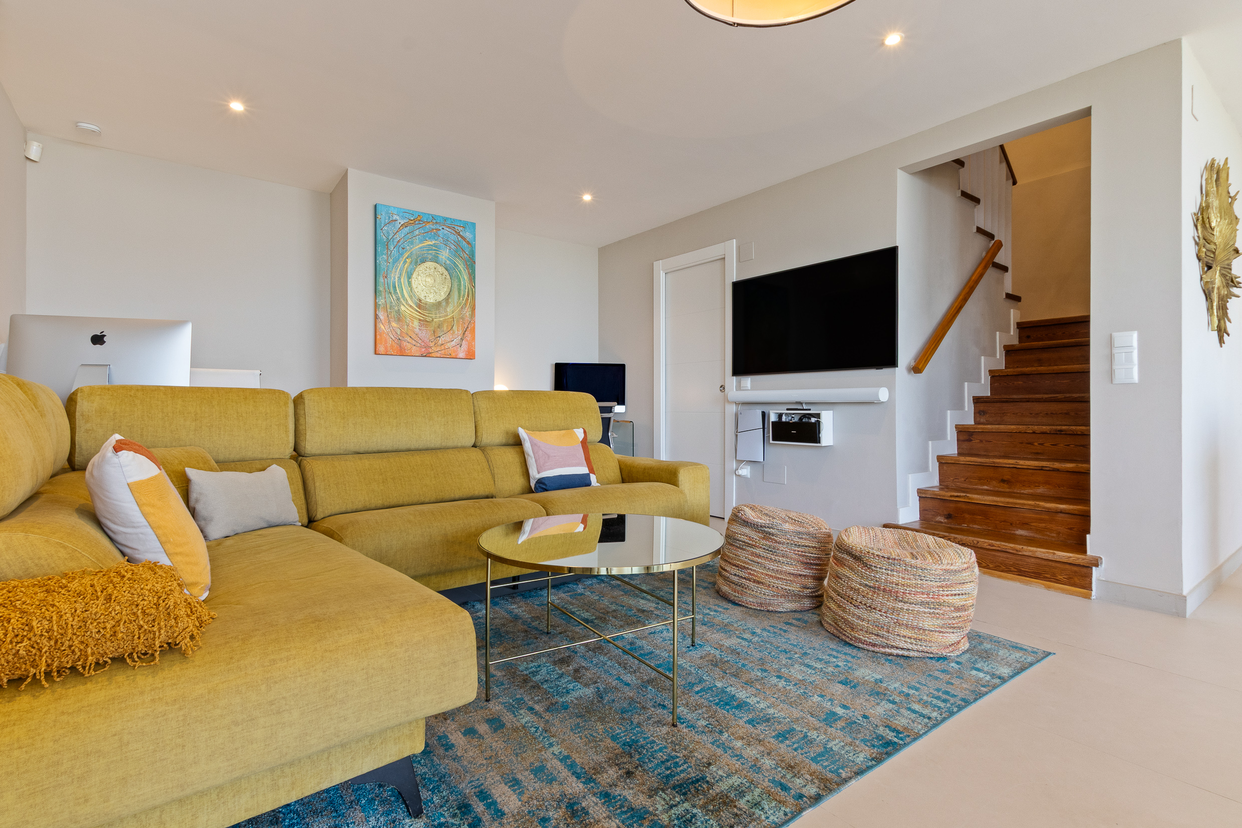 Main lounge with TV area and staircase detail