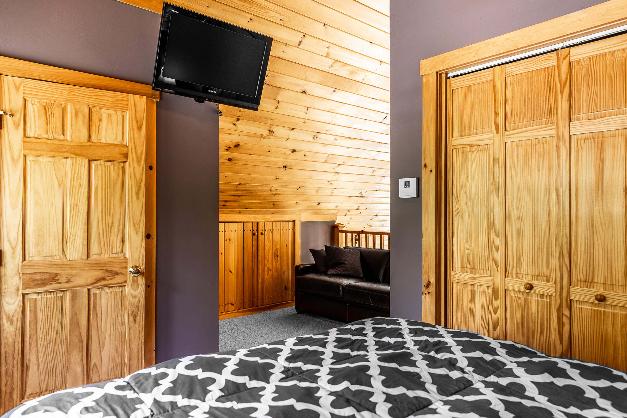 Upstairs loft with queen bed, sleeper sofa, and 1/2 bathroom. Roku TV, closet, ceiling fan.