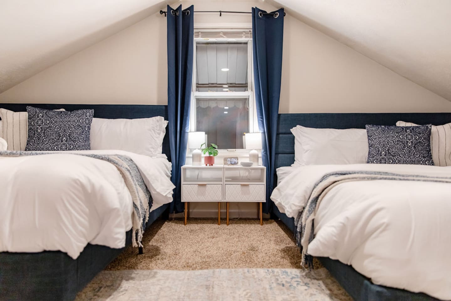 Spacious bedroom featuring two king beds, offering ample comfort and plenty of space for families or groups looking to relax together.