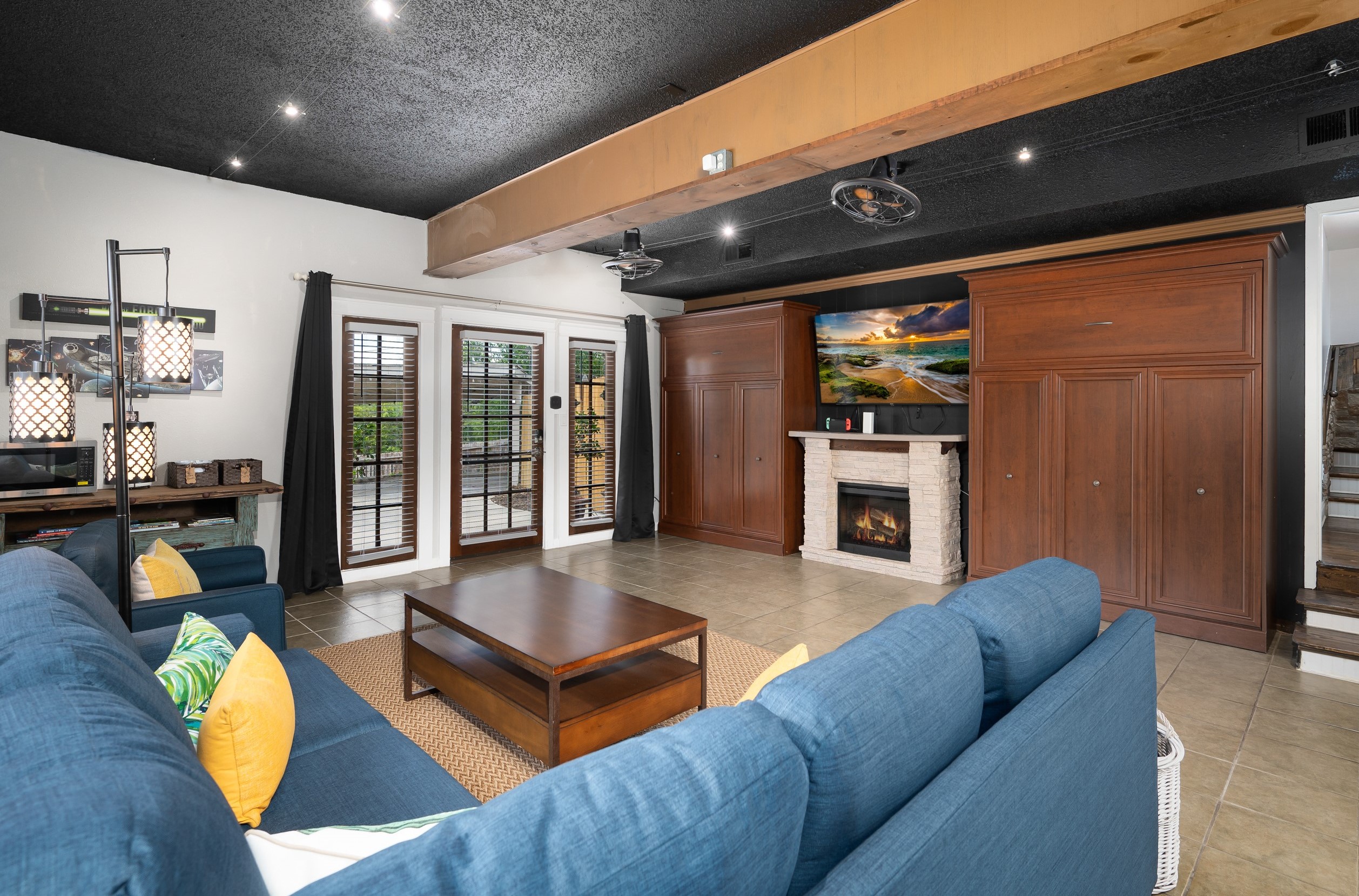 2nd Living Room we call "The Movie Room". Features two queen murphy beds,  sectional couch TV with nintendo switch.