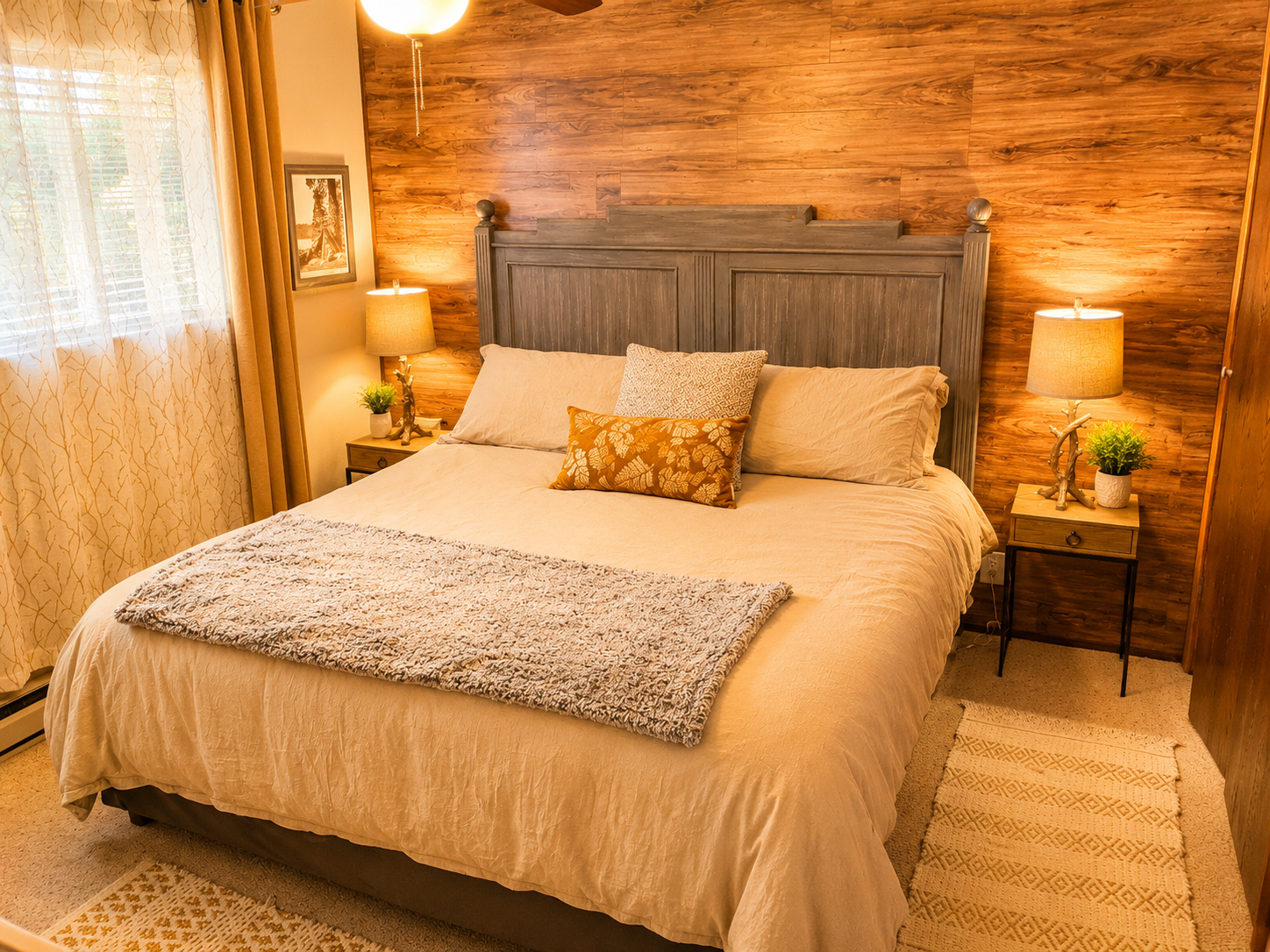 This bedroom is one of two bedrooms on the first floor of the cabin.  It has a king size bed, two nights stands with reading lights, room darkening shades with curtains, baseboard heating, a closet and dresser.