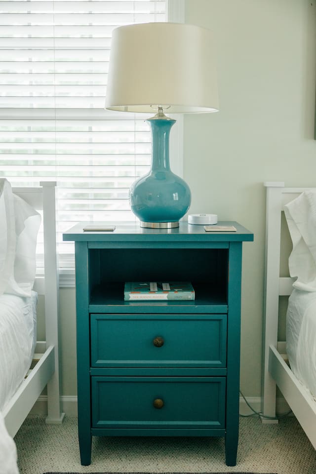 Nightstand with charging port. Books and earplugs available in the drawers. 