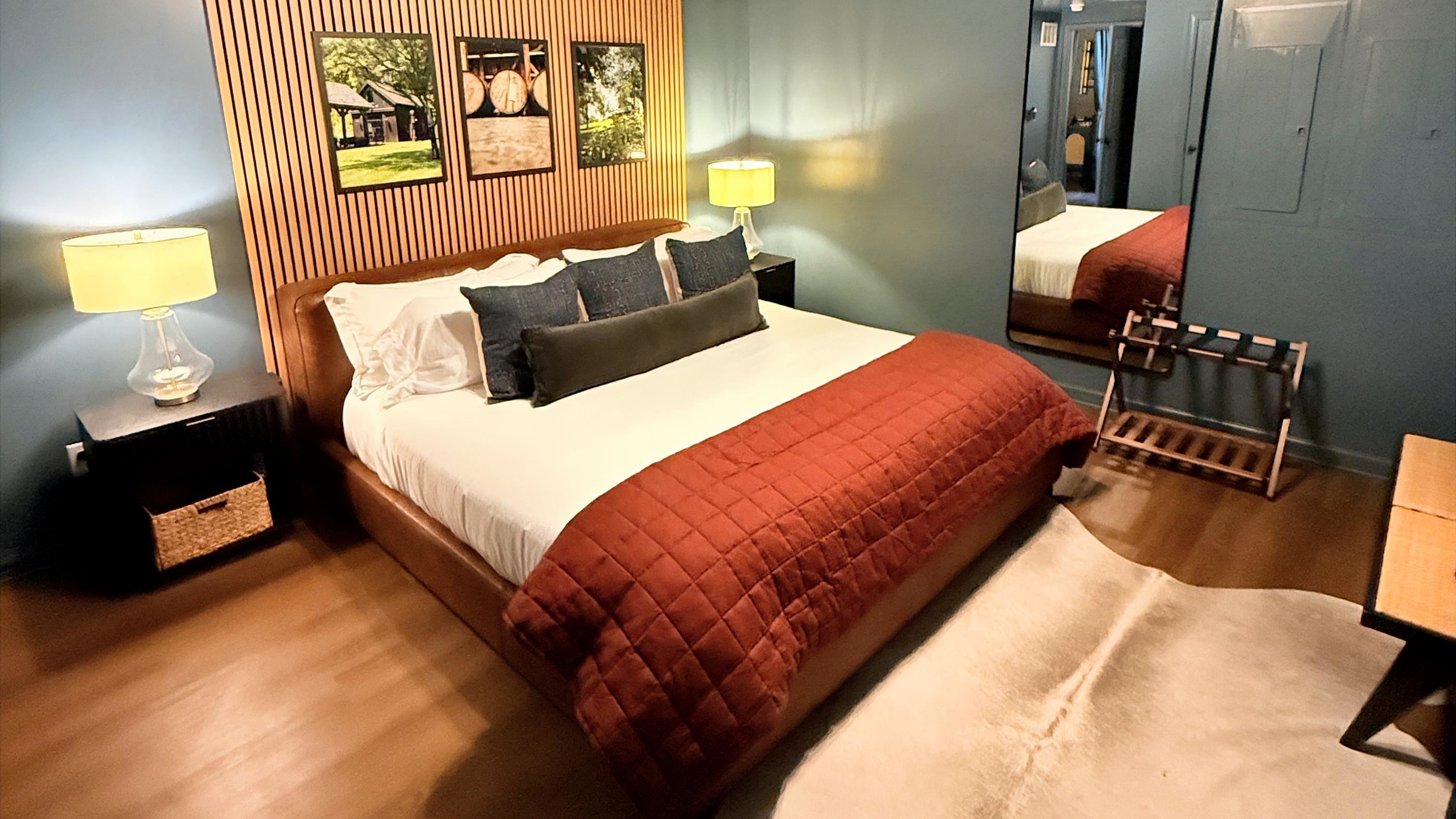 Texture meets tranquility — the slatted wall and layered design evoke quiet sophistication, where craftsmanship and comfort come together in true bourbon-country style, complete with USB-equipped nightstands for modern ease.