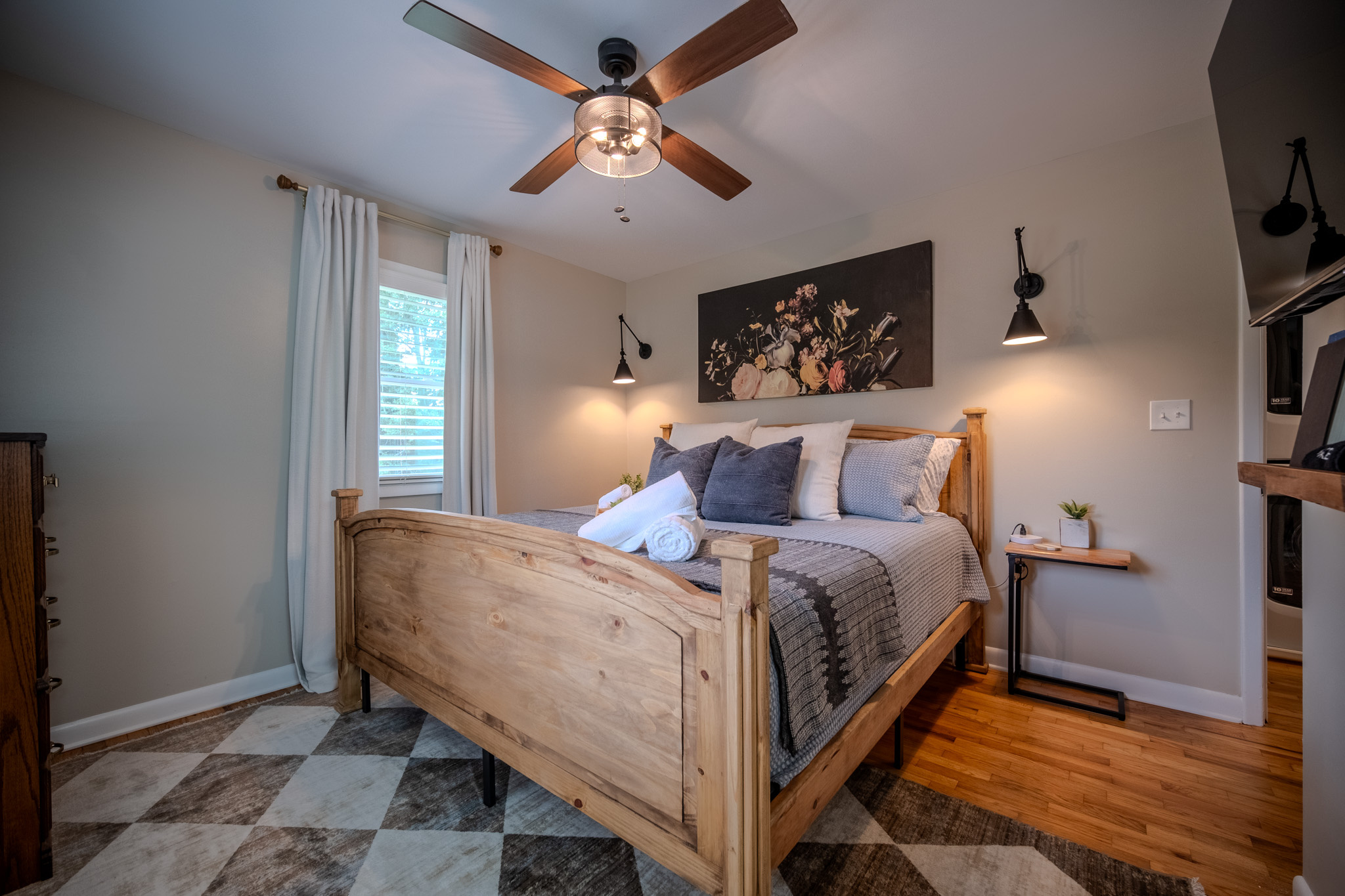 Comfortable primary suite featuring a king bed, smart TV, and private ensuite bathroom.