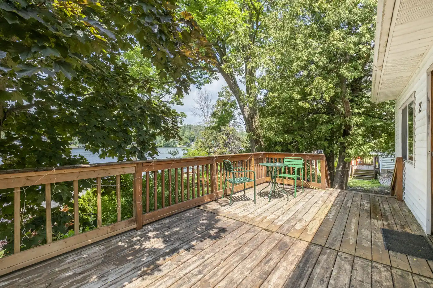 Private deck at Cottage #2 surrounded by mature trees
