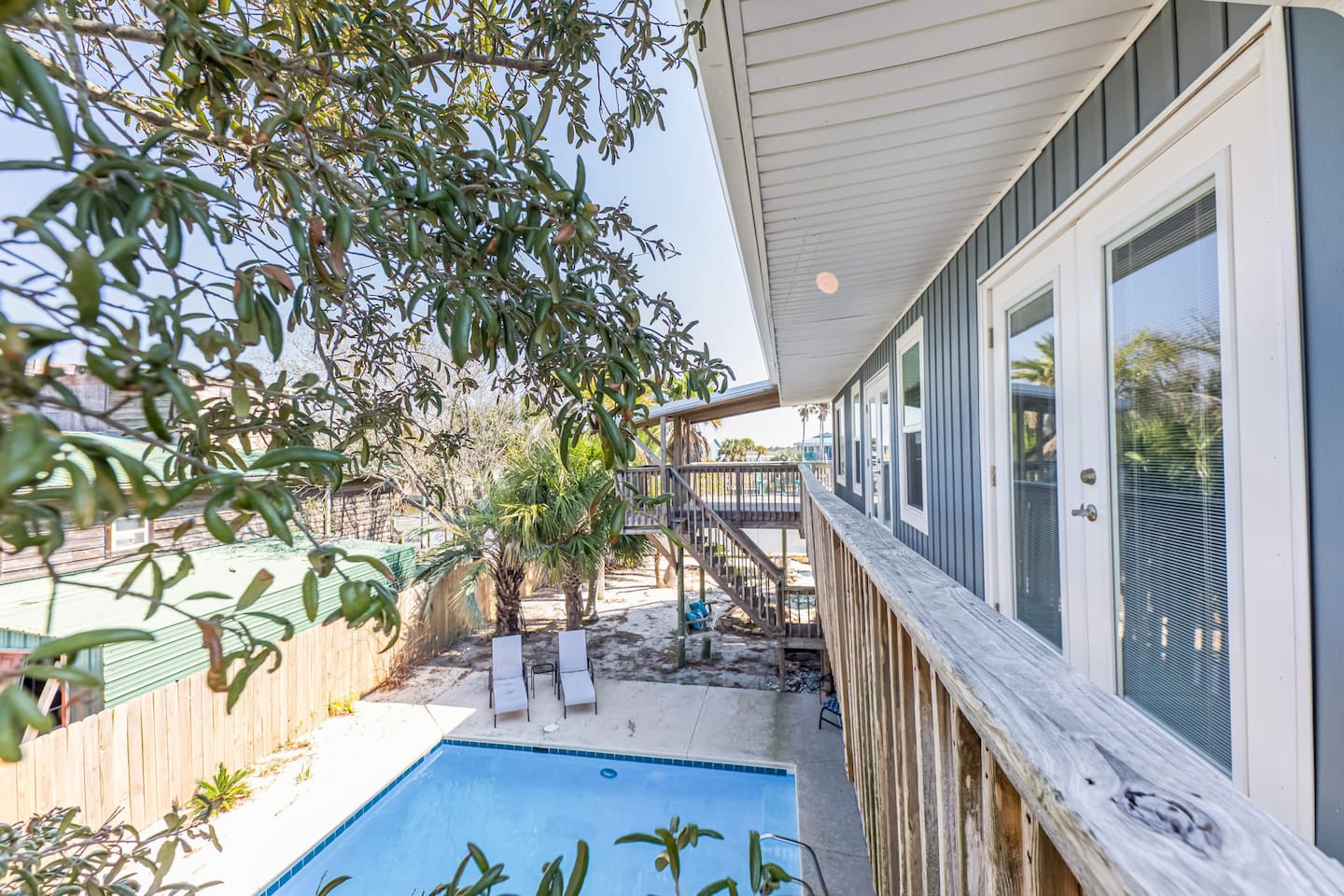 Exterior Oasis: Enjoy sunny days by the pool with lush palm views in Gulf Shores’ paradise!