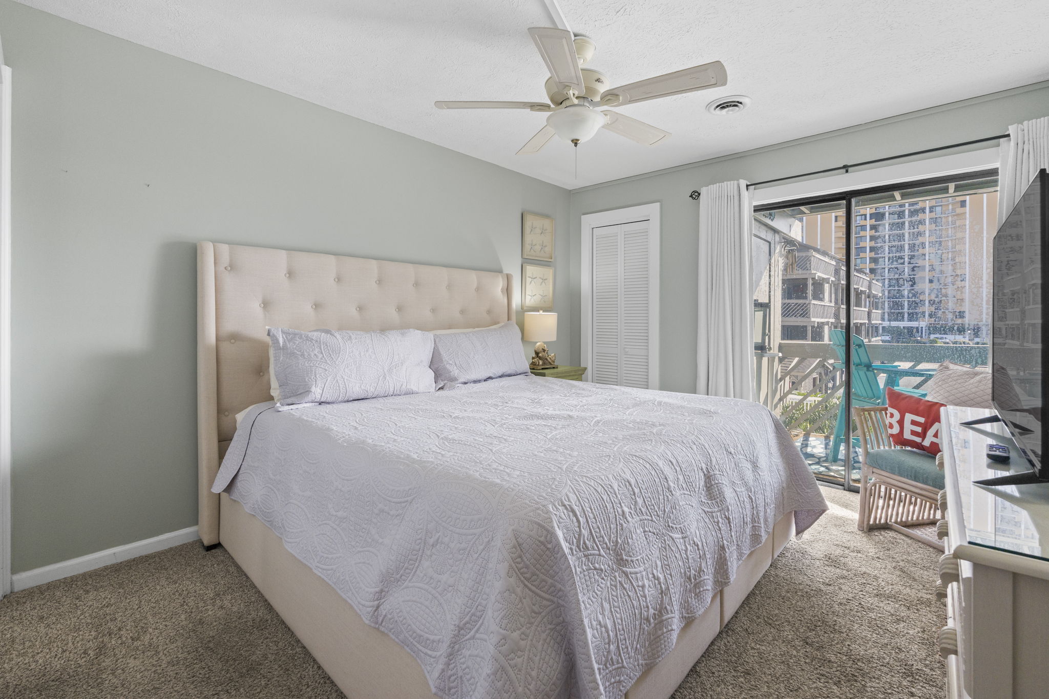Master Bedroom with King bed, ensuite bathroom and oceanview balcony overlooking pools and ocean