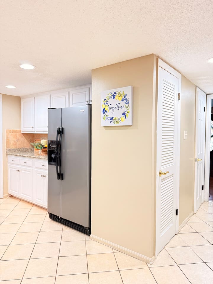 Spacious stainless steel refrigerator offers plenty of storage — perfect for longer stays, grocery runs, or group meals.