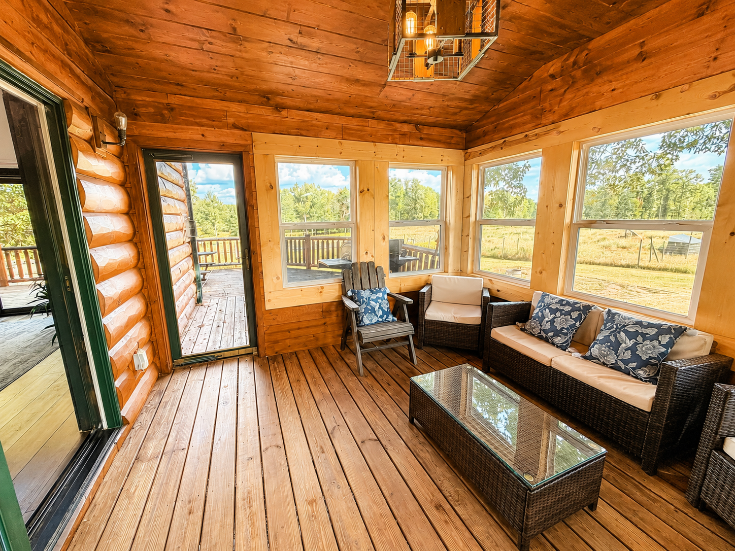 Panoramic view form the sunroom windows overlooking the surrounding Northwoods property. Step through the door onto the large deck. 

