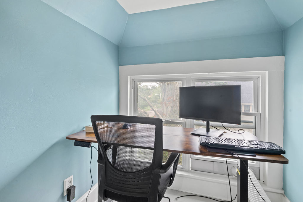 Upstairs Loft Desk where we provide a monitor and keyboard for you to use if you would like. The desk is a sit/stand desk.