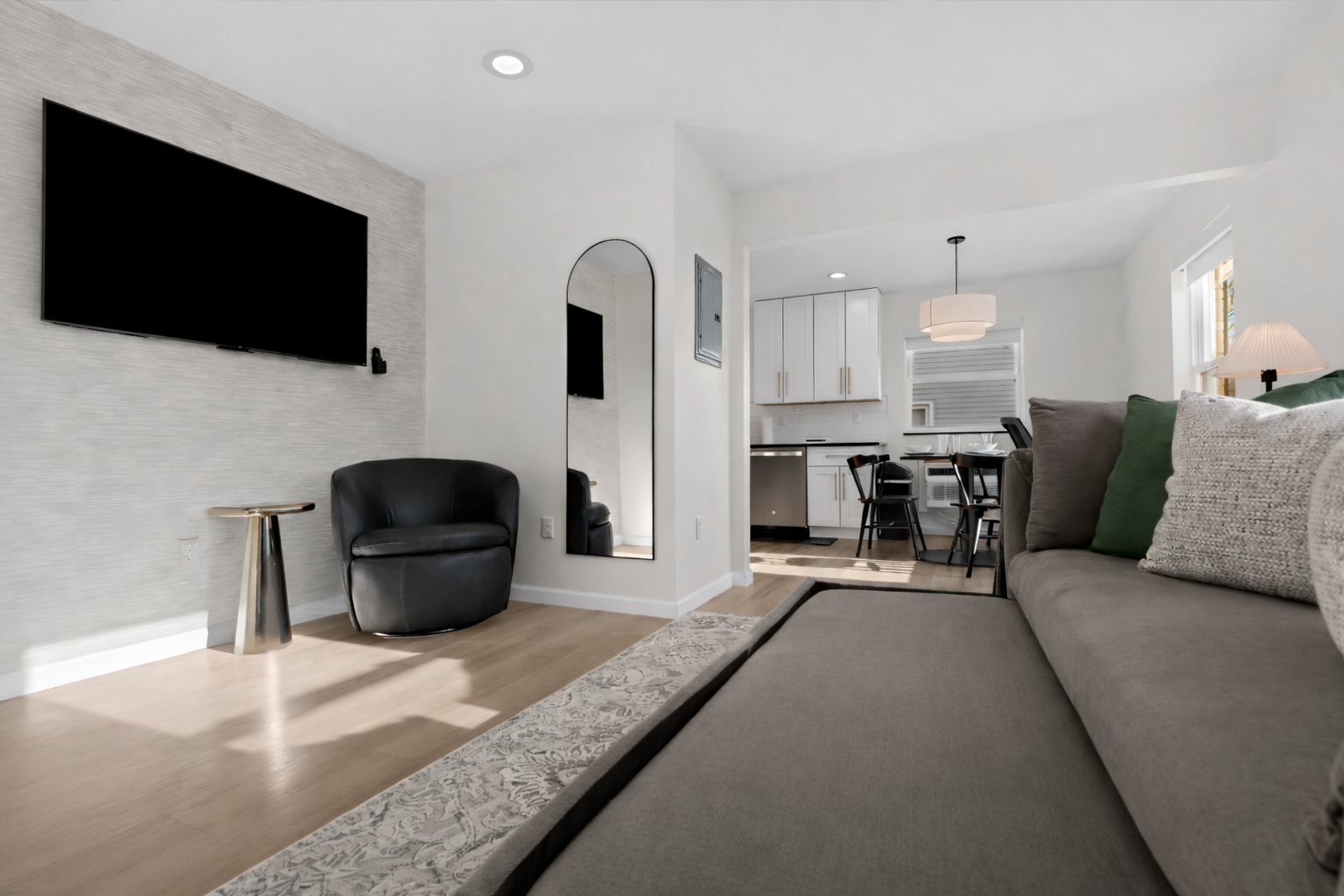 Open, modern living space with a pull-out sofa, smart TV, and stylish seating—perfect for relaxing, entertaining, or hosting additional guests.
