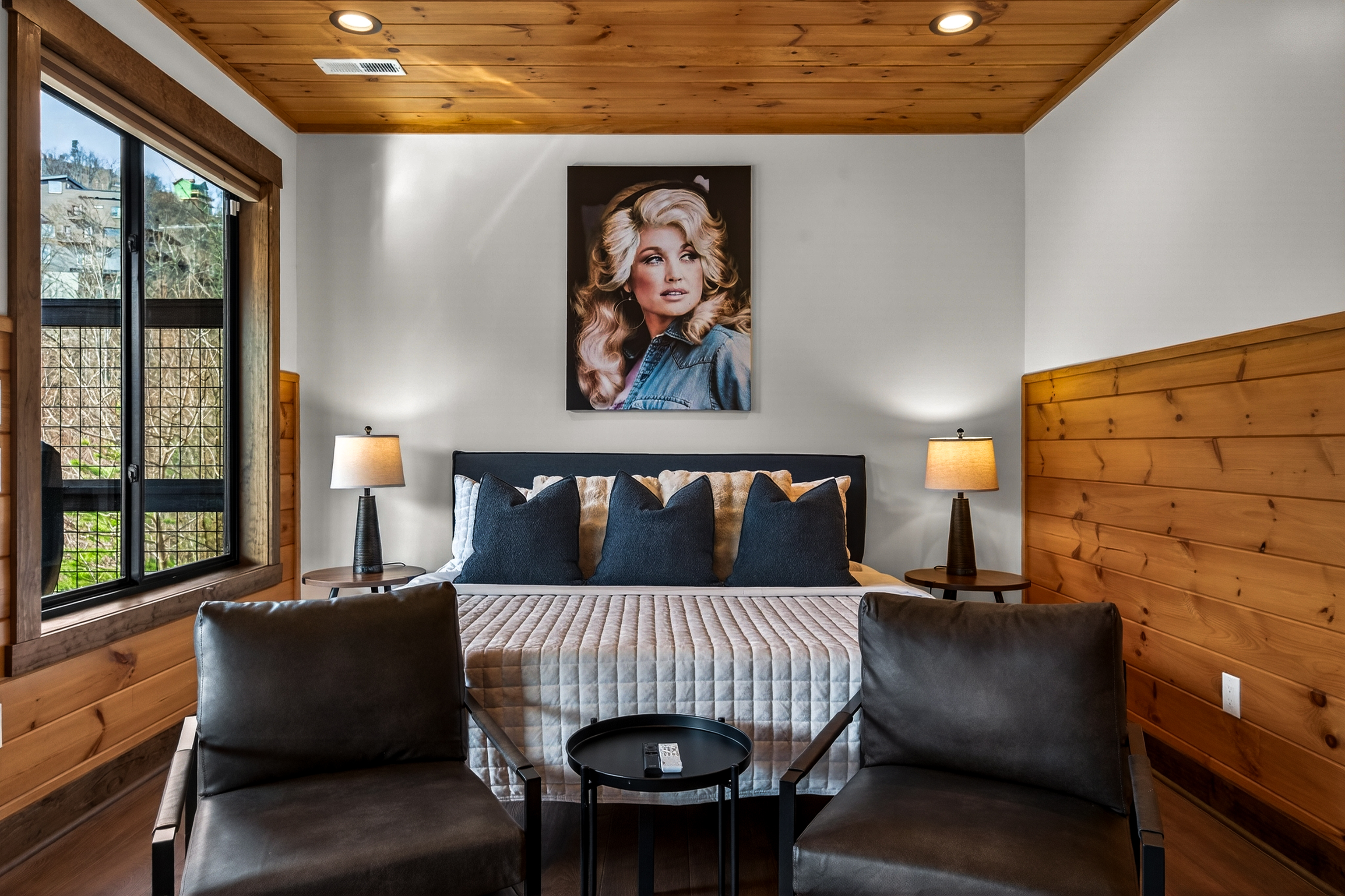 Relax in the spacious king bedroom on the game room level with a big TV, desk & direct deck hot tub access. Unwind in the en-suite bathroom featuring a walk-in shower with a natural river rock floor, bringing  the Smoky Mountains indoors for a spa retreat.