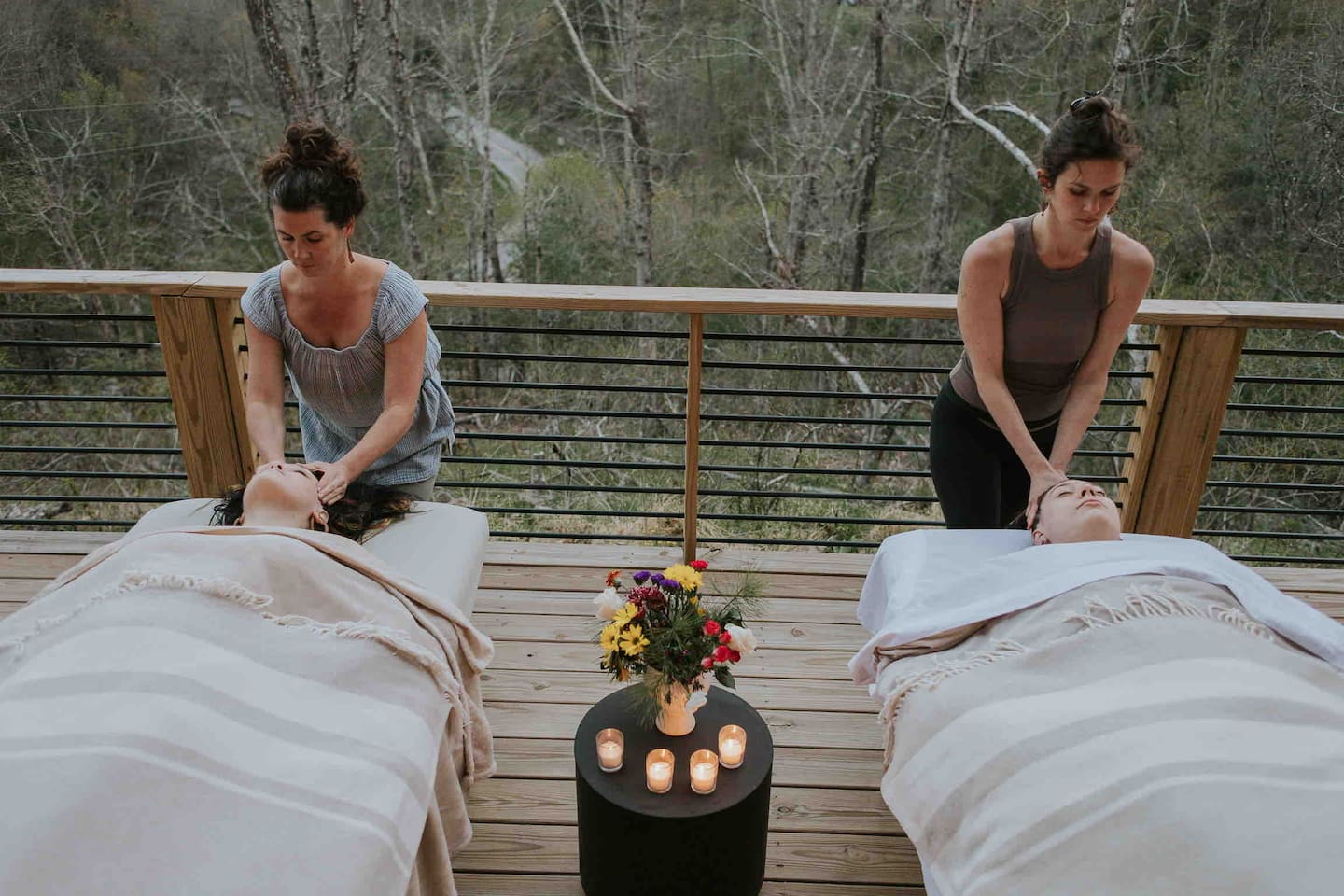 Book an onsite couples massage through Asheville Wellness Tours. Massages can be enjoyed inside by the fire or in nature on the deck. ashevillewellnesstours.com