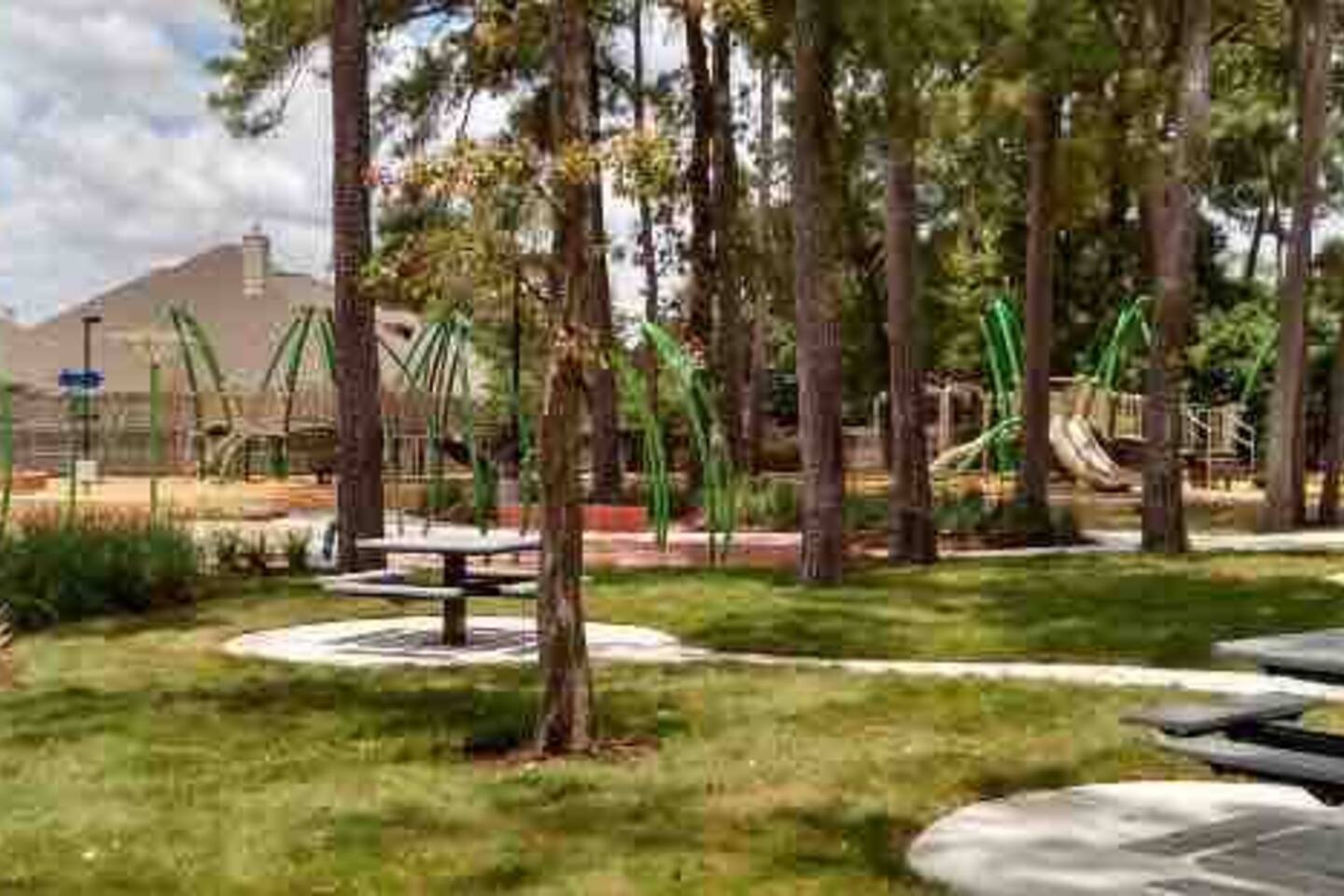 Large park with splash pad, tennis courts, basketball courts, a field, and more. 