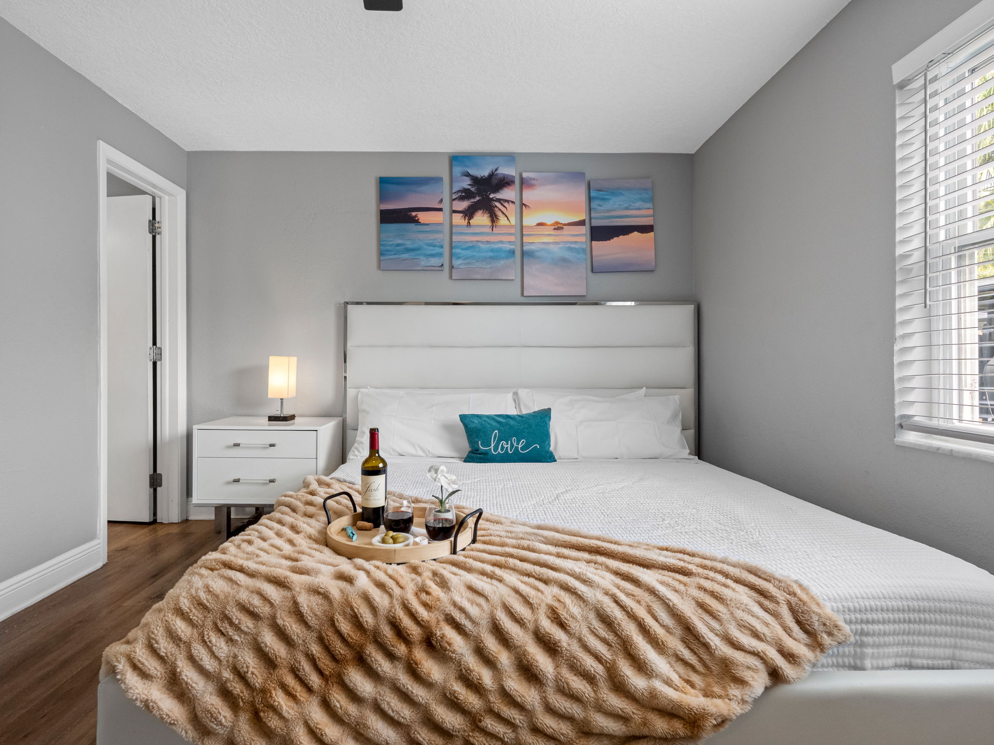 Everything you need for a perfect night in—stylish furnishings, blackout blinds, a ceiling fan, and entertainment right at your fingertips.