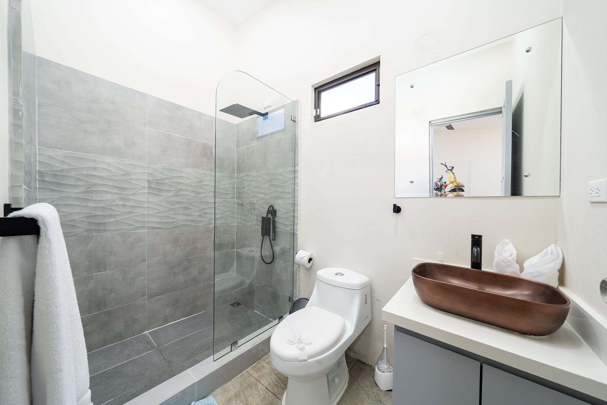 The first ensuite bathroom has a walk in shower and copper sink