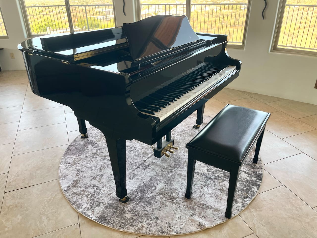 Music lovers will appreciate the grand piano set beside the room’s wide windows.