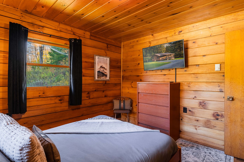 Unwind in the serene master bedroom, complete with a full-size bed, soft linens, and a 43" smart TV for a little screen time before bed.