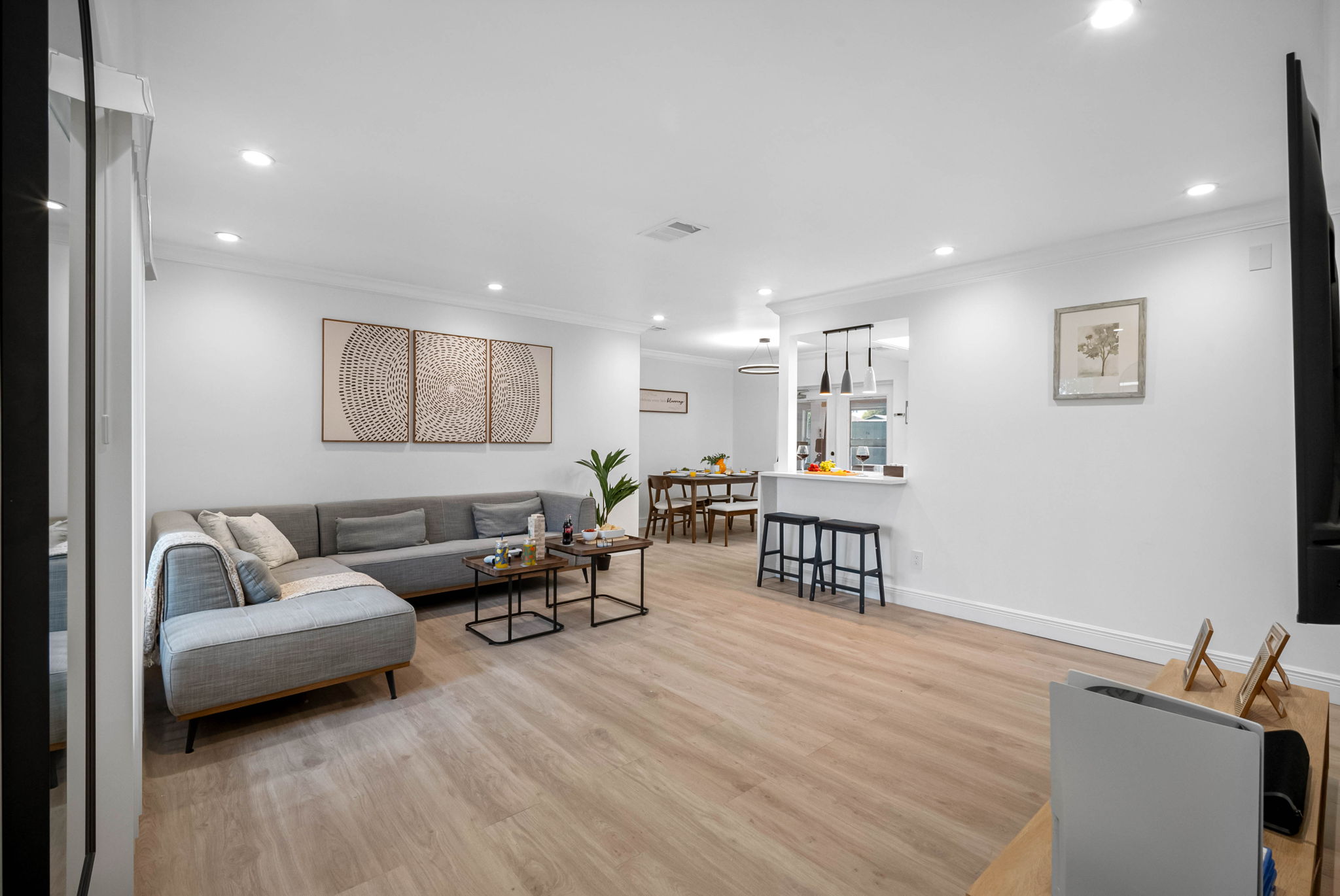 This open-concept living room is flooded with natural light and designed for relaxation, with thoughtful details and cozy touches.