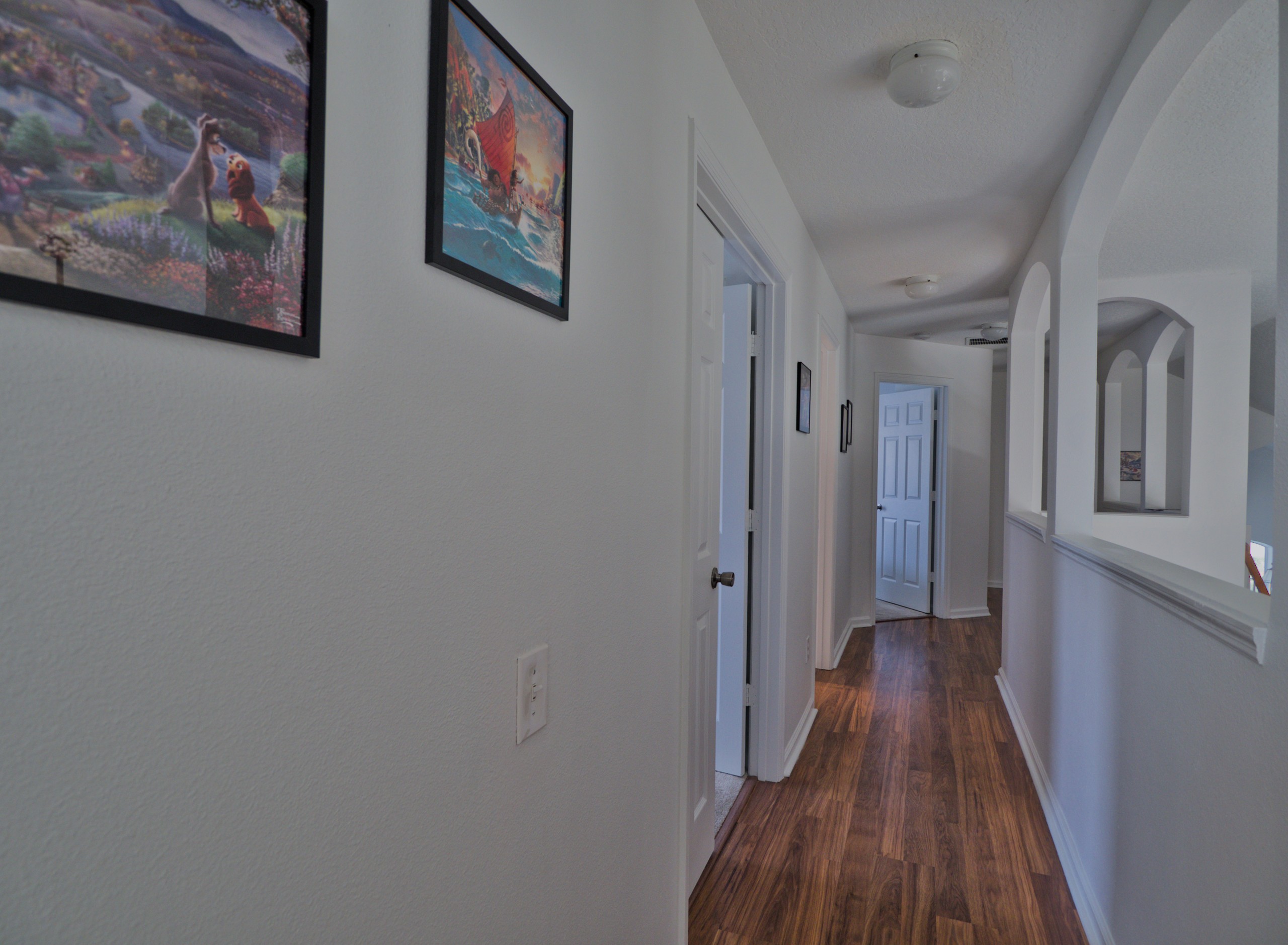 Hallway with Disney art.