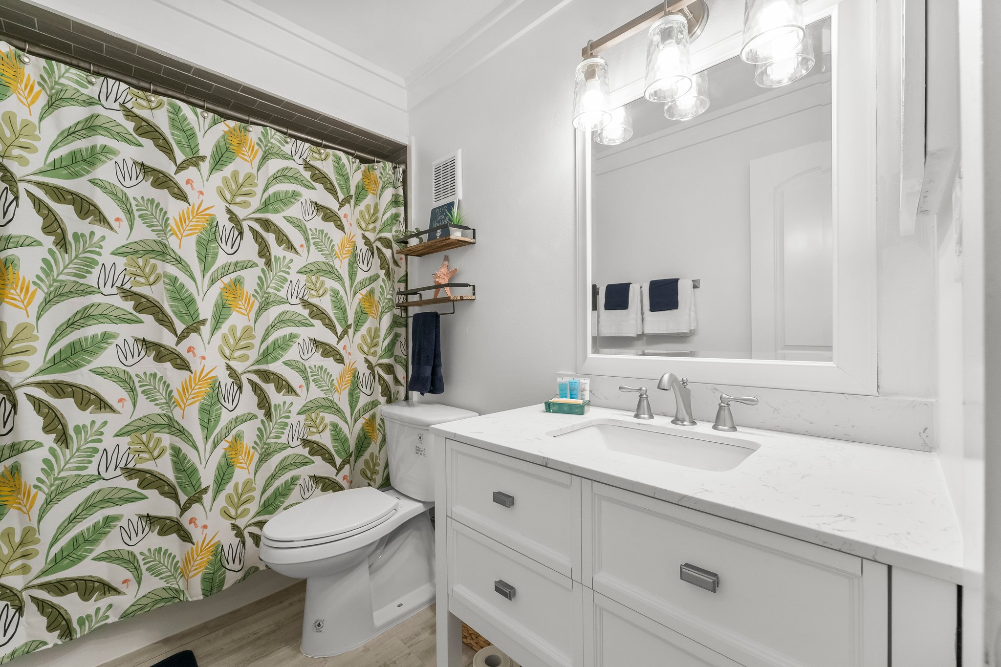 Start your day feeling rejuvenated or prepare for a night on the town in our coastal-inspired master suite, where every morning feels like a breath of fresh ocean air!