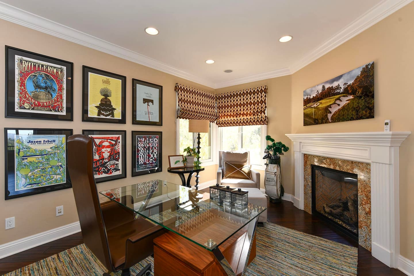 Office with desk, chair, and fireplace.