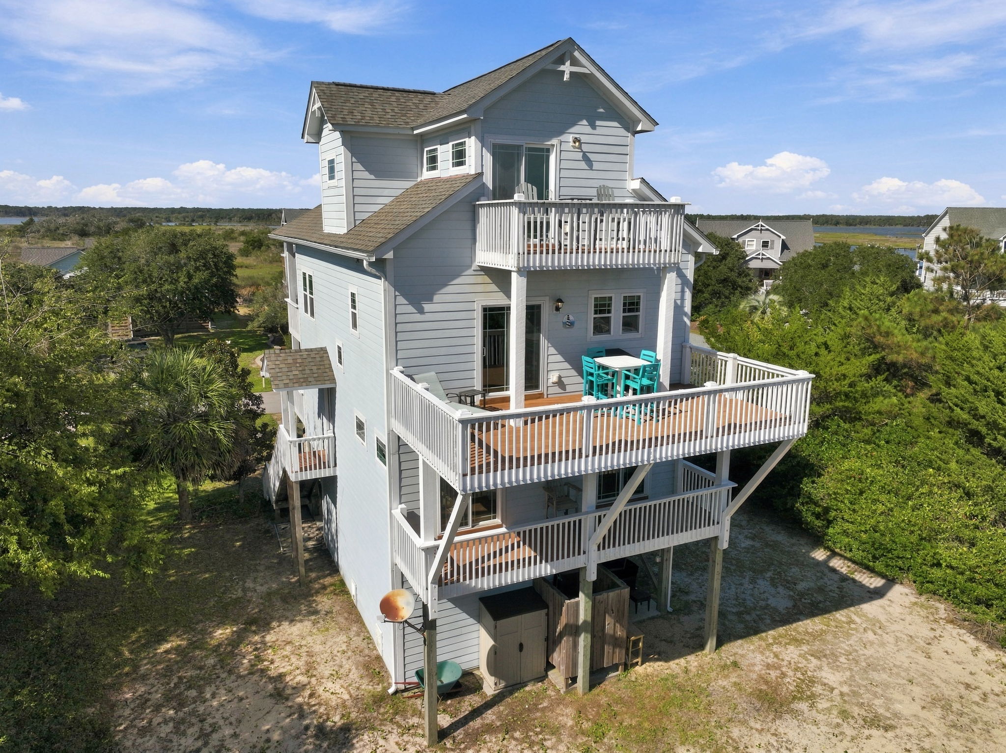 Beautiful coastal home featuring multiple levels of outdoor decking and inviting spaces to unwind