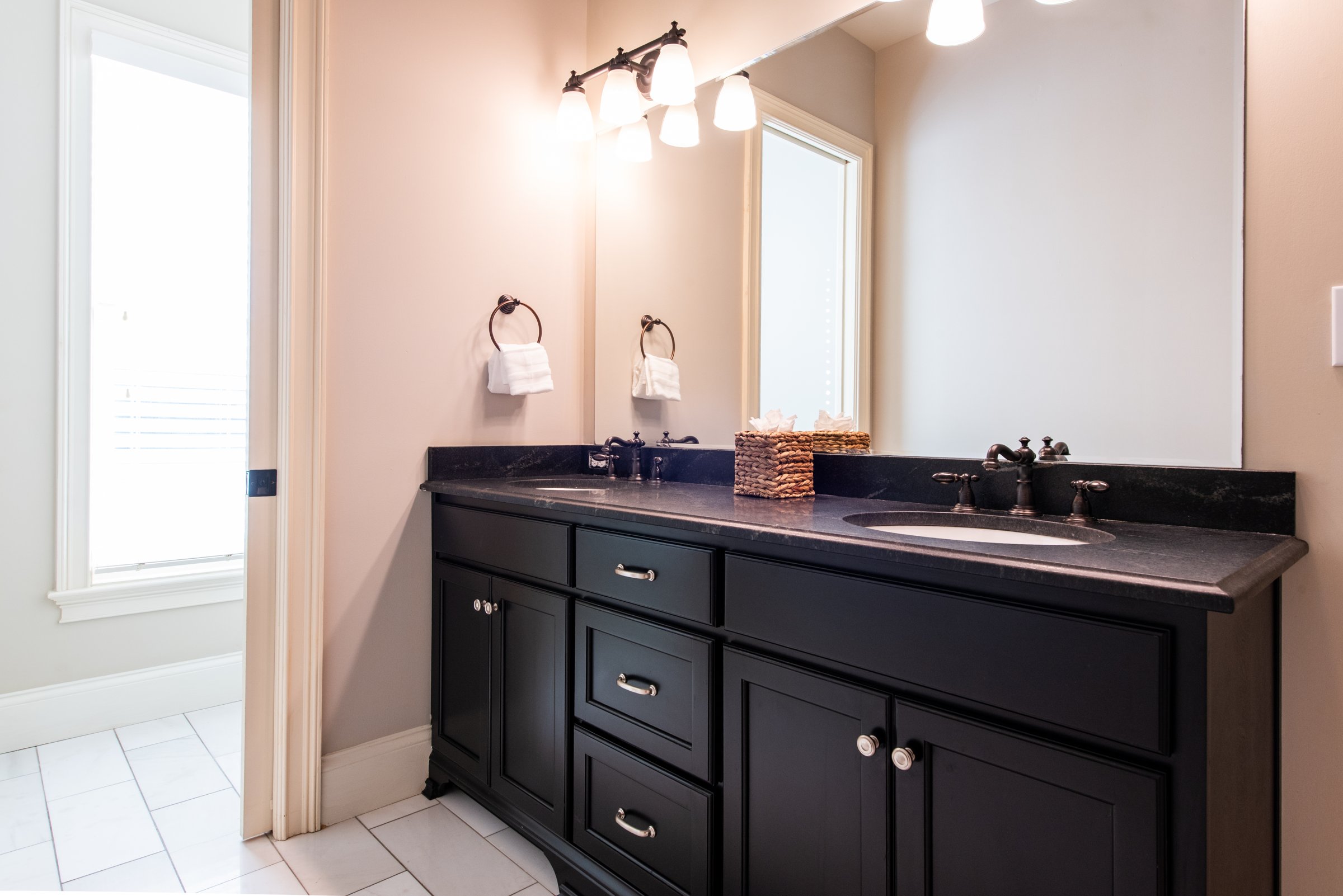 Double vanity with quartz countertops in the spa-like primary bathroom.