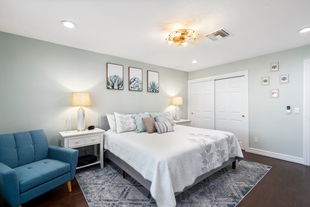 Spacious primary suite with a king bed, stylish dresser and nightstands.