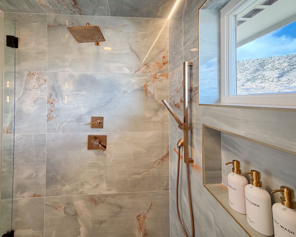 Step into a two-person custom shower adorned with unique, handcrafted tile and enjoy complimentary soaps for a luxurious, spa-like experience.”