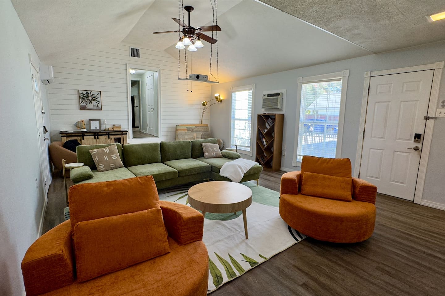 Spacious, inviting lounge with comfortable sectional seating, cozy accent chairs, natural light, and an open layout ideal for relaxing or gathering with friends.