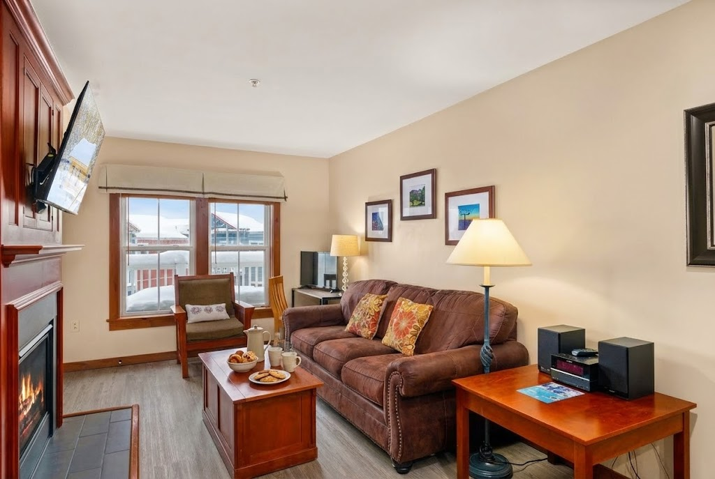 Catch up with Friends & Family in this Living Room with a Smart TV & Fireplace