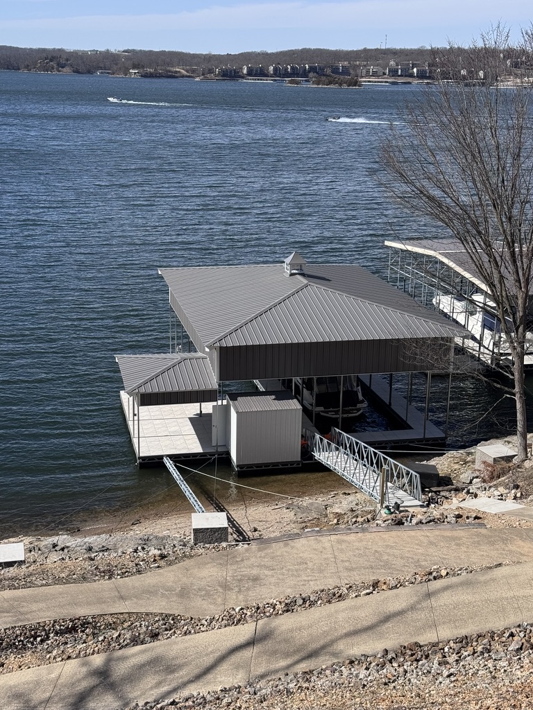 Brand new concrete dock (March 2026) with covered boat slip 10'x32' and swim deck.