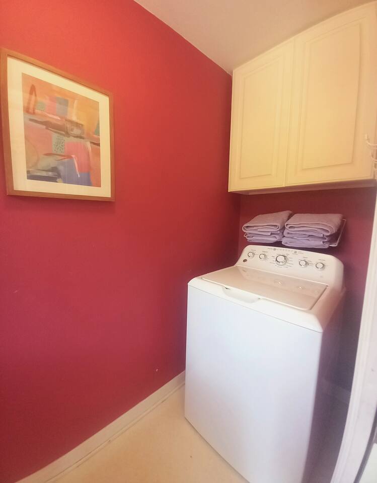 Full-sized washer and dryer in private laundry includes ironing board, drying rack and drying line, storage for cleaning supplies.  Pool towels and pool noodles stored here also!