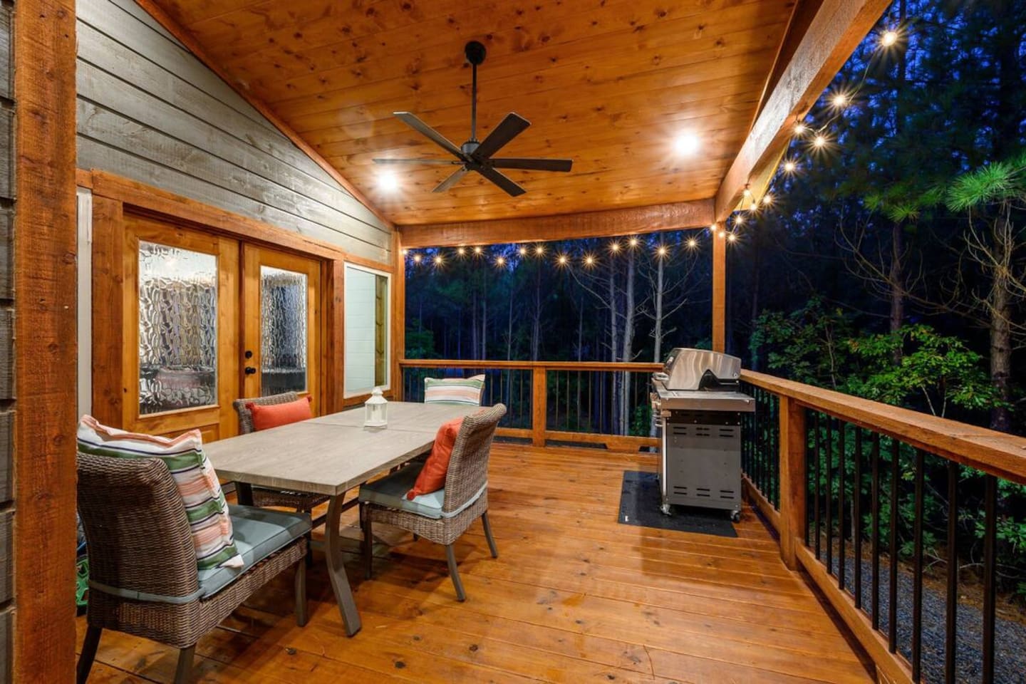 Outdoor living redefined: dining table, BBQ grill,  and peaceful forest sounds.
