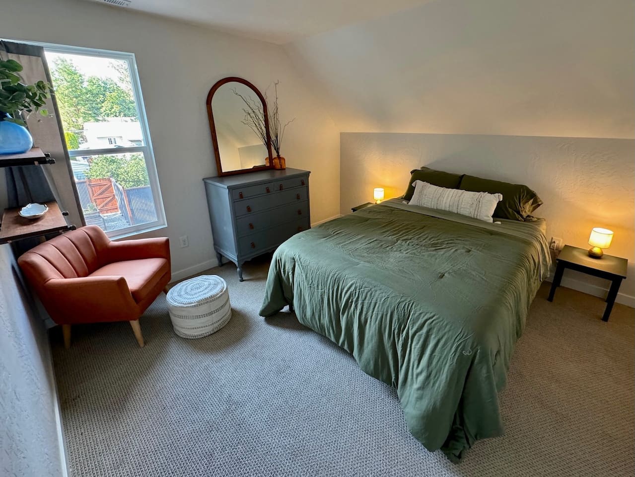 This bedroom features a queen bed, black out curtain, and a generous walk-in closet space. 