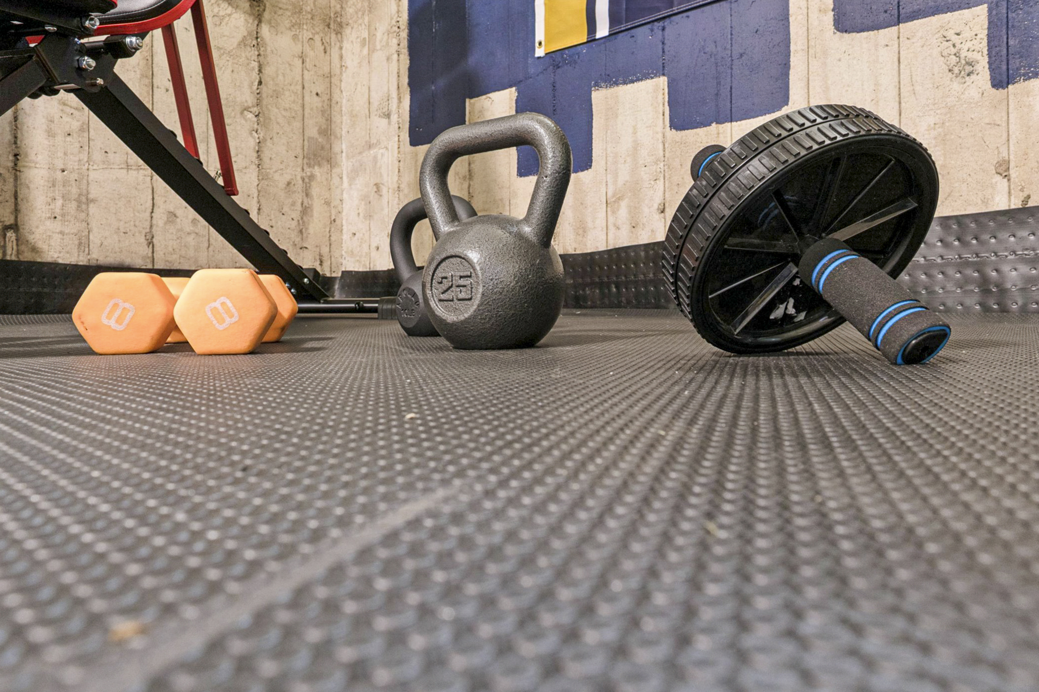Get moving—our South Bend guest retreat sports floor features an ab roller, kettlebells, and dumbbells, all provided to support your workout goals with Fighting Irish spirit near Notre Dame.