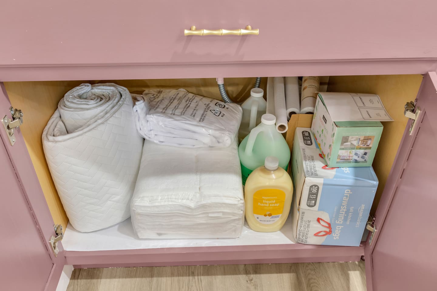 Every detail covered: under-sink storage includes backup linens, hand and body soap, kitchen supplies, and all the essentials for a comfortable stay.