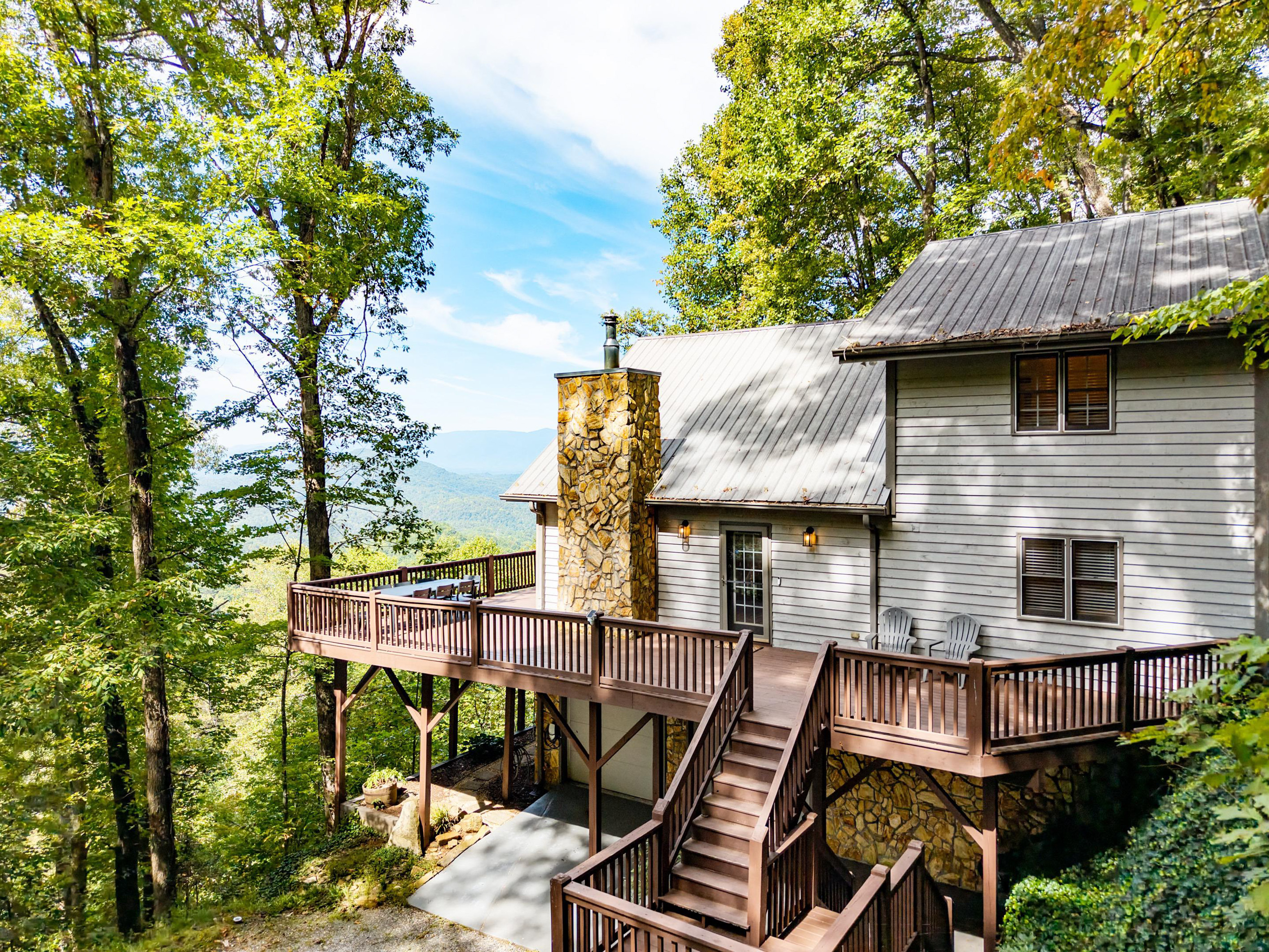 Take in the stunning mountain views from this side profile of the cabin, offering a perfect welcome before you step inside and a beautiful sight as you hea