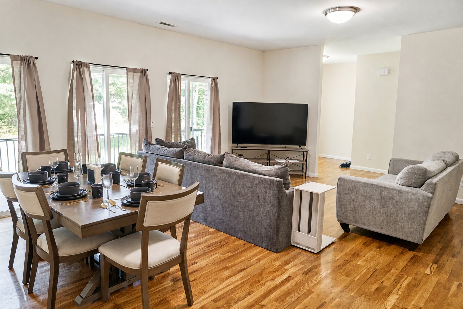 Open-plan living and dining room with sliding doors to the deck