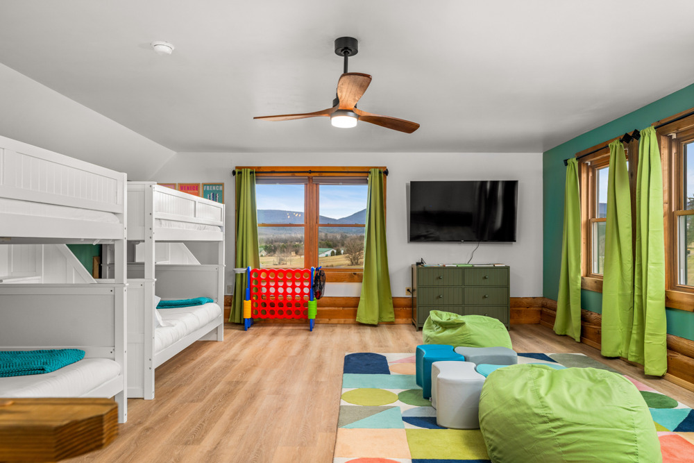 Spacious room with two full bunk beds, seating area, and a view.