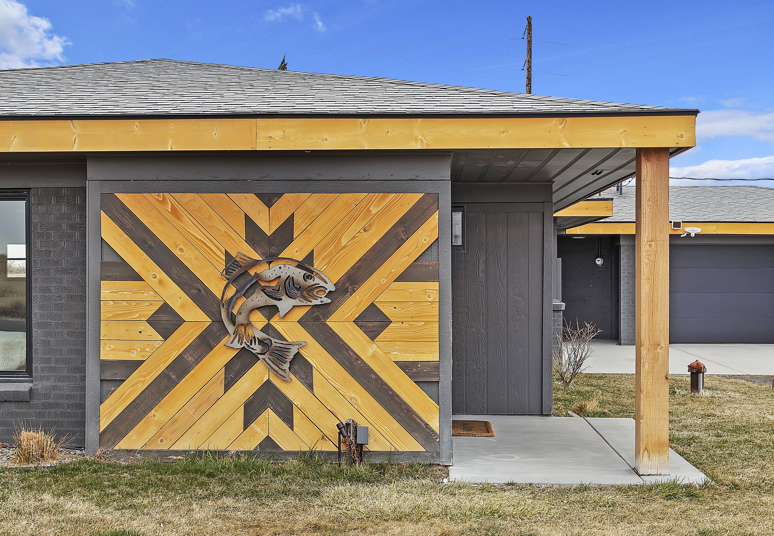 The home's welcoming front entrance and mid-century lines and custom hand crafted artwork.