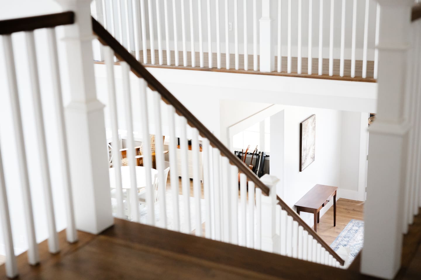 Front door entry is at bottom of grand staircase. You can see the library/music room at bottom of steps on the left, opposite the living/great room wall. The library/music room is partially open to the great room and foyer.