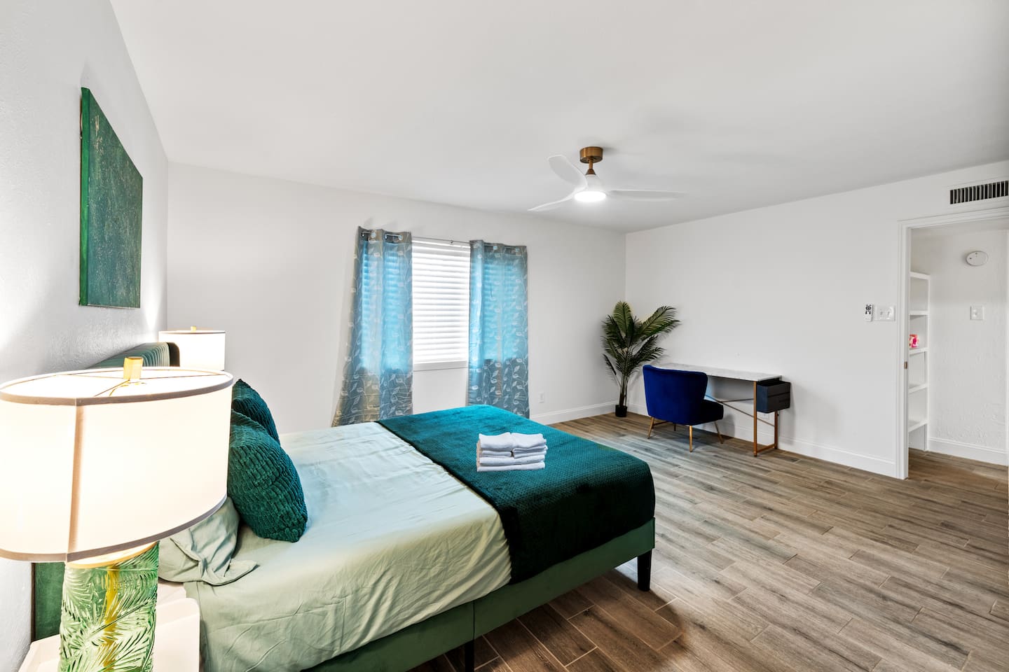 Relax in the stylish primary bedroom with vaulted ceilings and natural light.