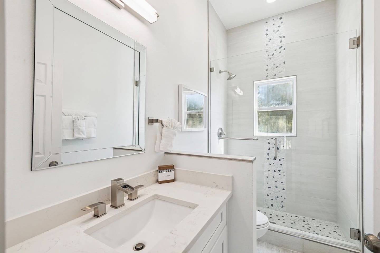 Contemporary bathroom complete with modern vanity fixtures and a walk-in glass shower.