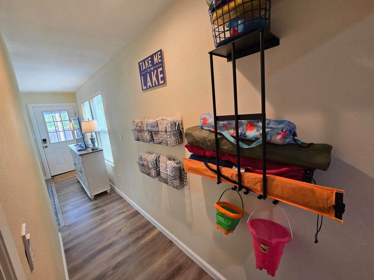 Feel free to borrow and return items along this wall, including chairs, kites, sand toys, and Turkish towels for use at the lake.