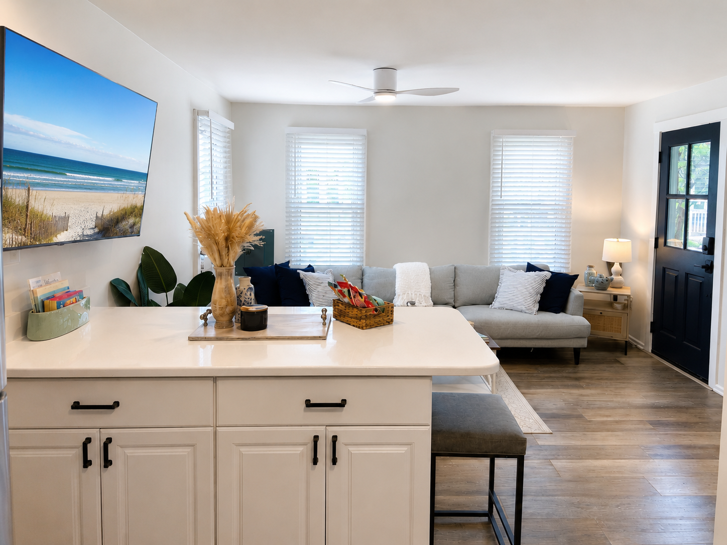 Step into the Embury Hideaway and feel the open living and kitchen breathe around you, with coastal art and a long island ready for your morning coffee.