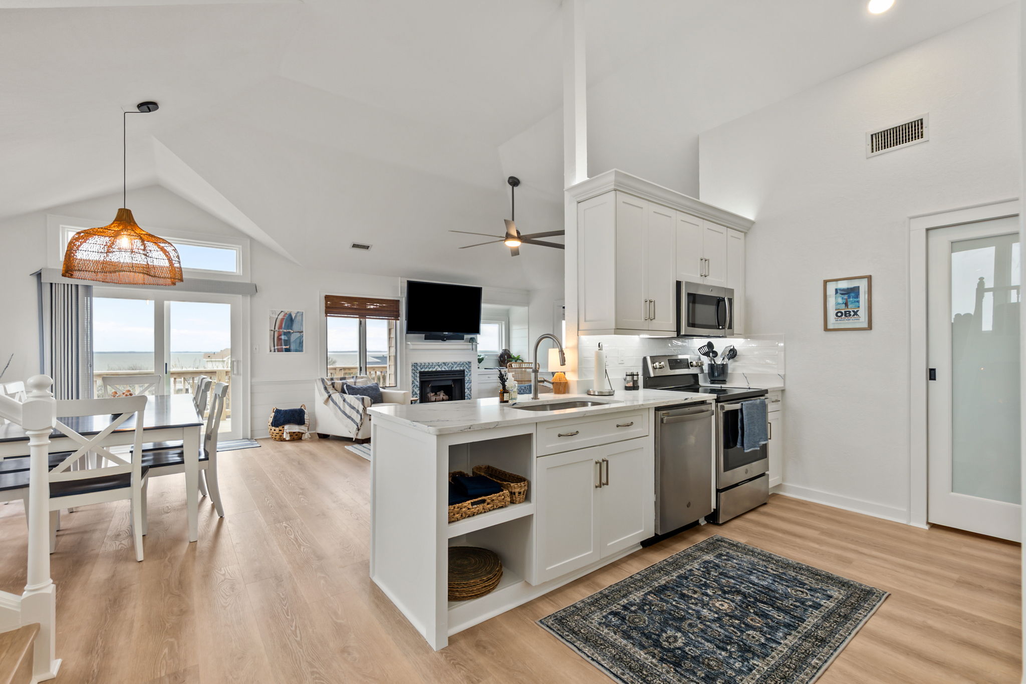 Open-concept living area with a bright kitchen, island seating, and easy flow into the dining and lounge space.