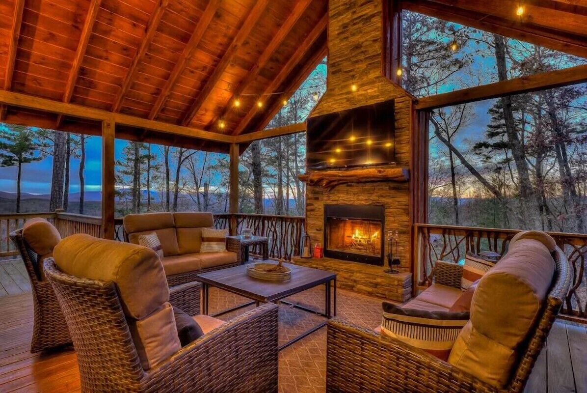 Covered deck with mountain views and stone fireplace at our Blue Ridge cabin