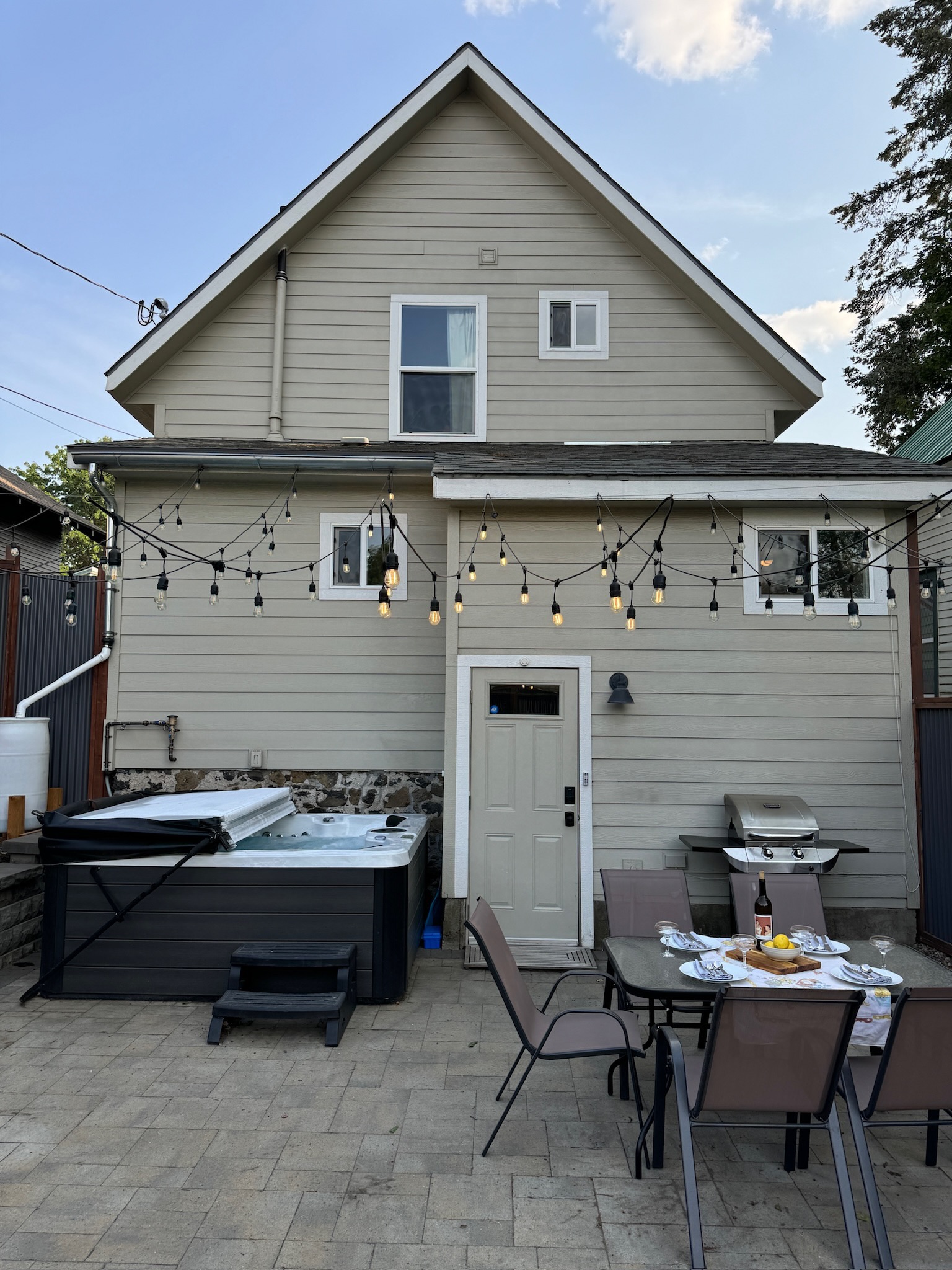 Enjoy dining outdoors on the patio in the fully fenced backyard. Then soak in the hot tub for maximum relaxation!

Guests are encouraged to create their own patio dining experience! Please note: the photographed wine is not included in your stay :) 